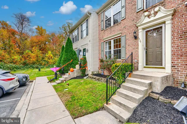 a view of a house with a yard and sitting area