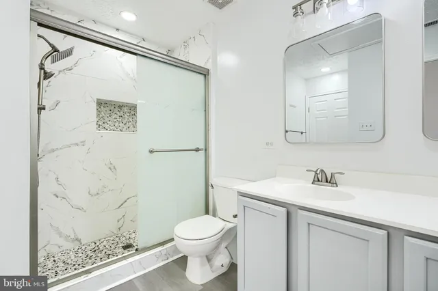a bathroom with a toilet sink and mirror