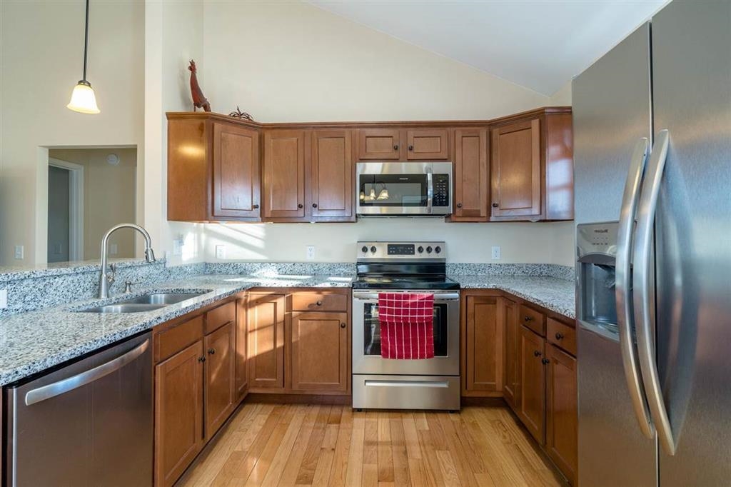 17480 Mt Pleasant Road Elkton, VA 22827 - Photo 4 of 14 a kitchen with stainless steel appliances granite countertop a stove a sink dishwasher a refrigerator and a microwave oven with wooden floor