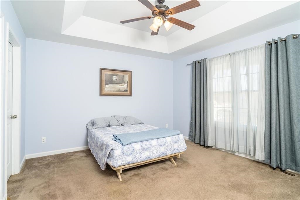 17480 Mt Pleasant Road Elkton, VA 22827 - Photo 10 of 14 a bedroom with a bed and a chandelier