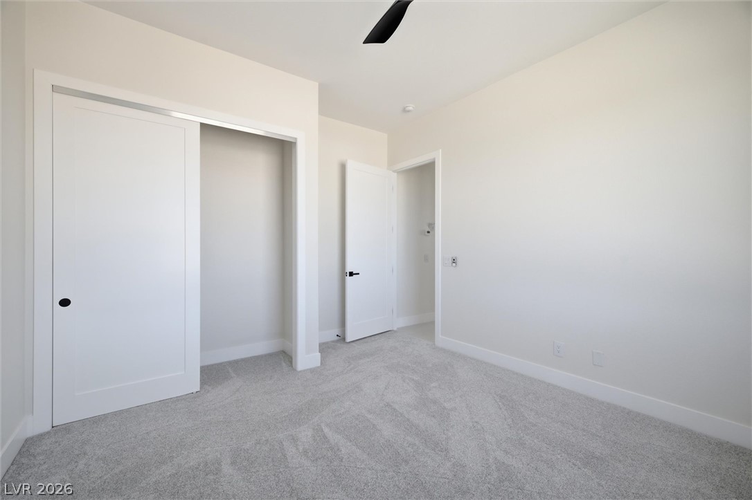 5910 East Kellogg Road Pahrump, NV 89061 - Photo 29 of 58 A spacious bedroom features fresh carpeting and bright white walls, ready for your personal touch.