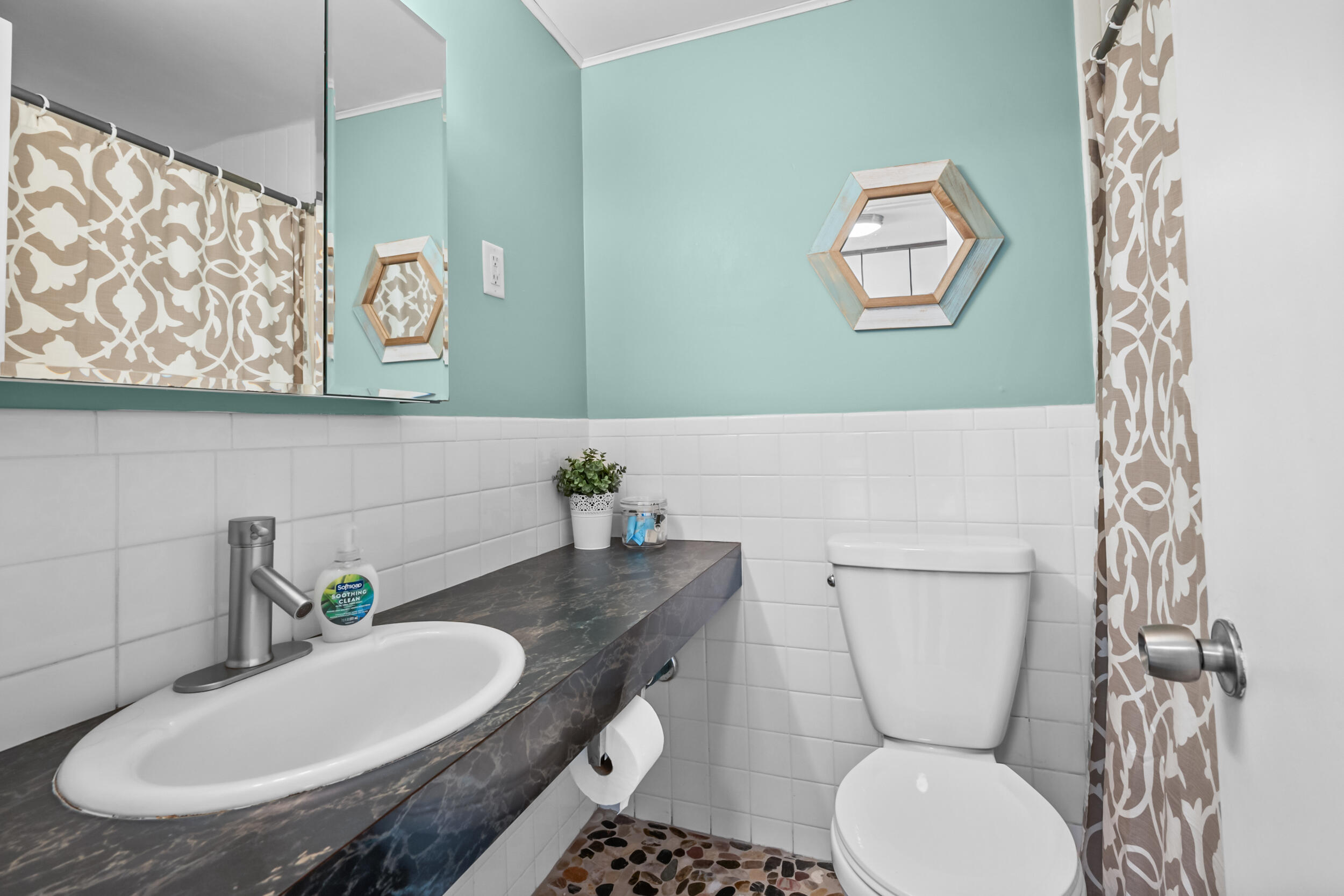 154 Old Wharf Road, Unit 36 Dennis Port, MA 02639 - Photo 15 of 28 a bathroom with a toilet a sink and mirror