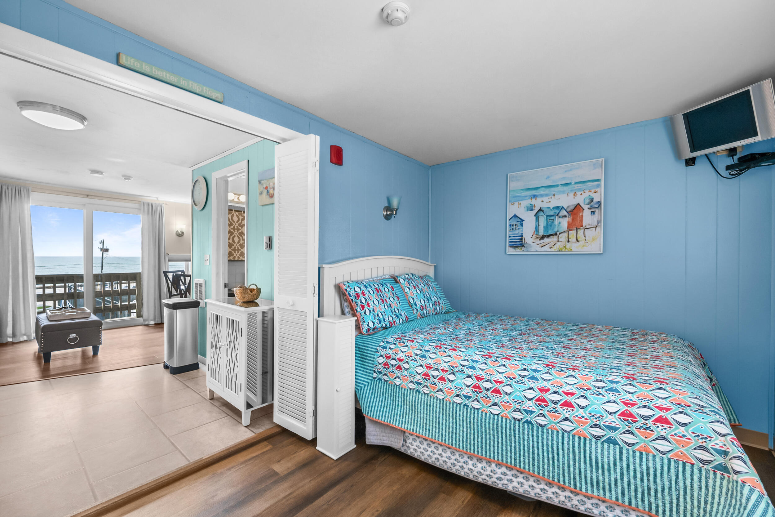 154 Old Wharf Road, Unit 36 Dennis Port, MA 02639 - Photo 17 of 28 a bedroom with a bed and glass wall