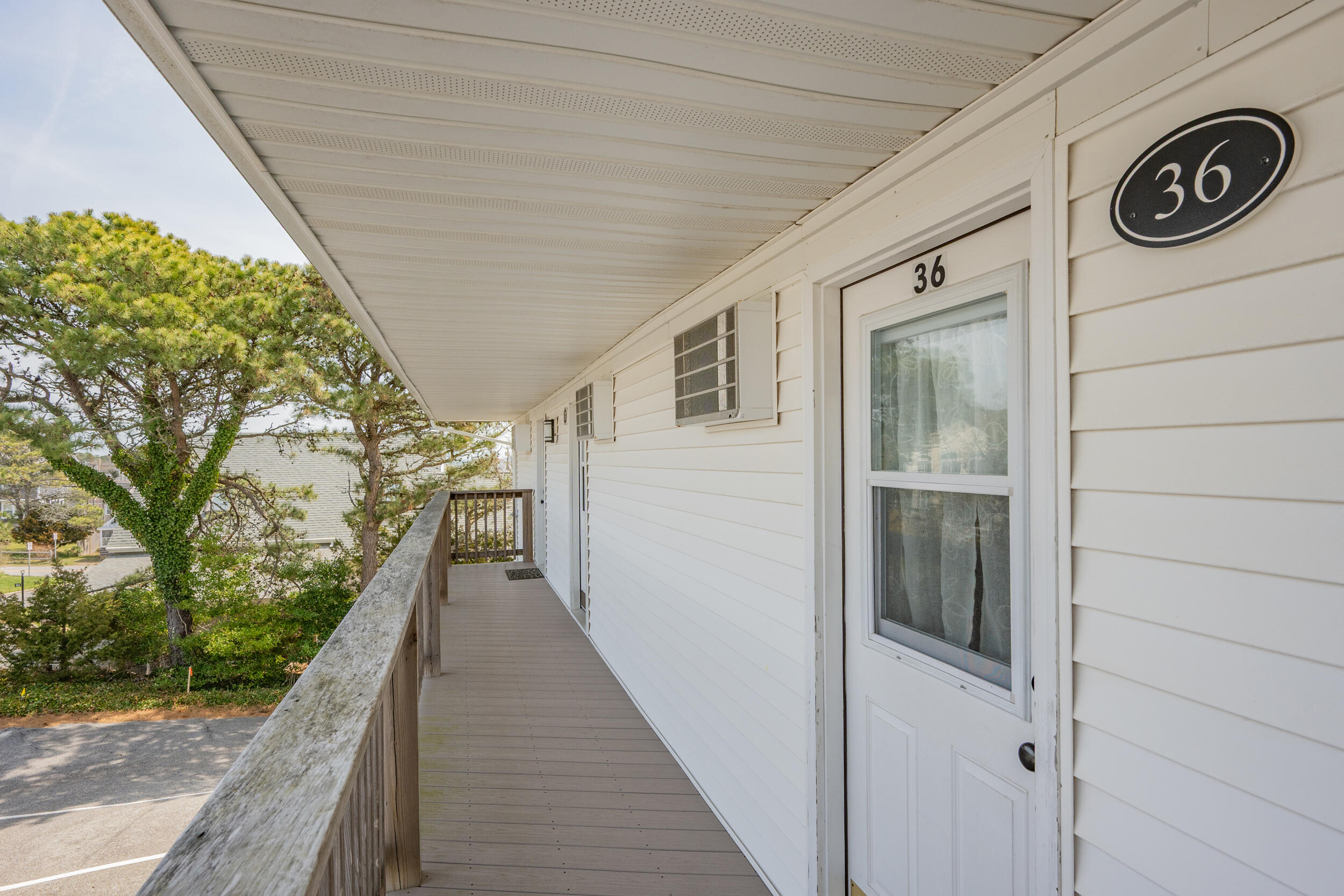 154 Old Wharf Road, Unit 36 Dennis Port, MA 02639 - Photo 18 of 28 a view of a pathway of a house with a balcony