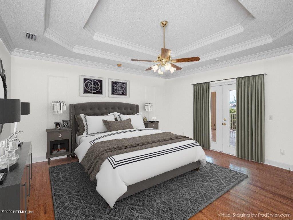 3664 Spinnaker Court Jacksonville, FL 32277 - Photo 13 of 42 a spacious bedroom with a bed and a chandelier