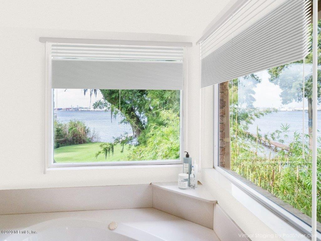 3664 Spinnaker Court Jacksonville, FL 32277 - Photo 14 of 42 a bathroom with a bathtub and window