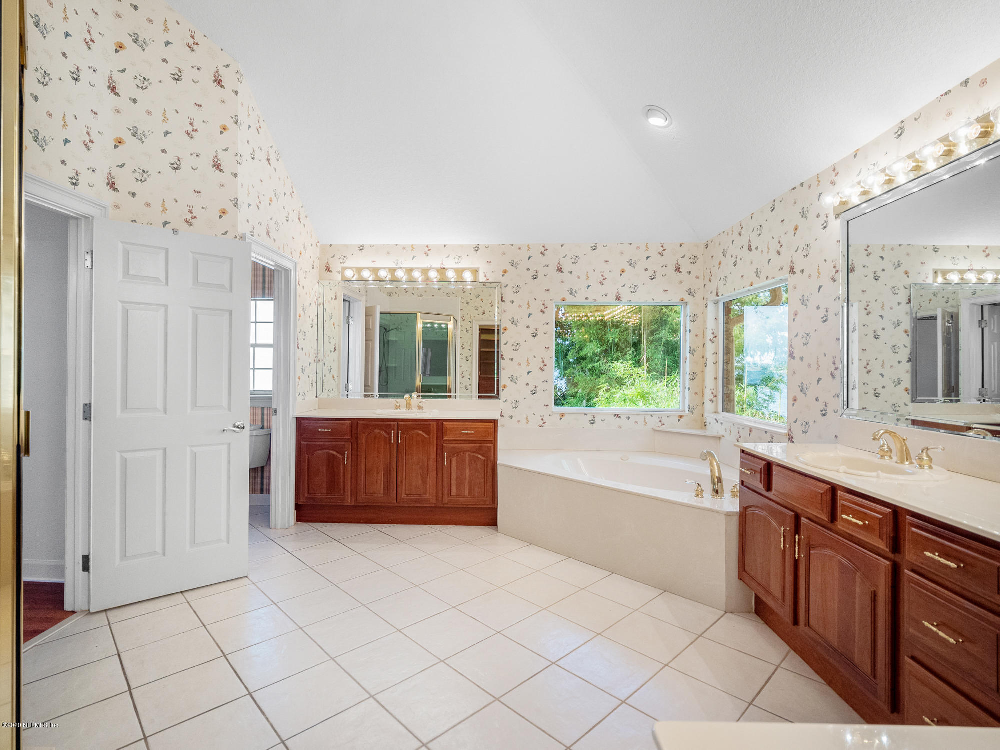 3664 Spinnaker Court Jacksonville, FL 32277 - Photo 15 of 42 a bathroom with a tub sink and mirror