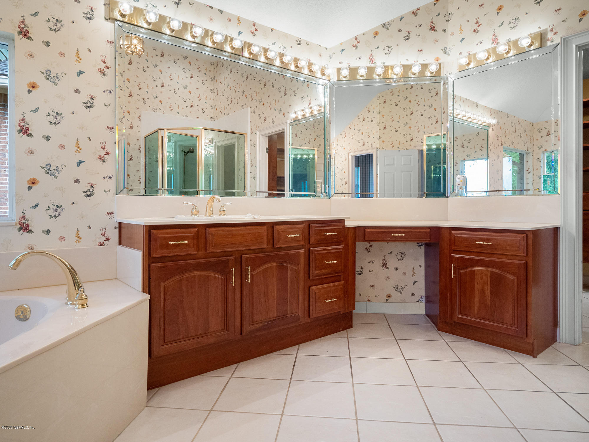 3664 Spinnaker Court Jacksonville, FL 32277 - Photo 16 of 42 a spacious bathroom with a sink a vanity and a mirror