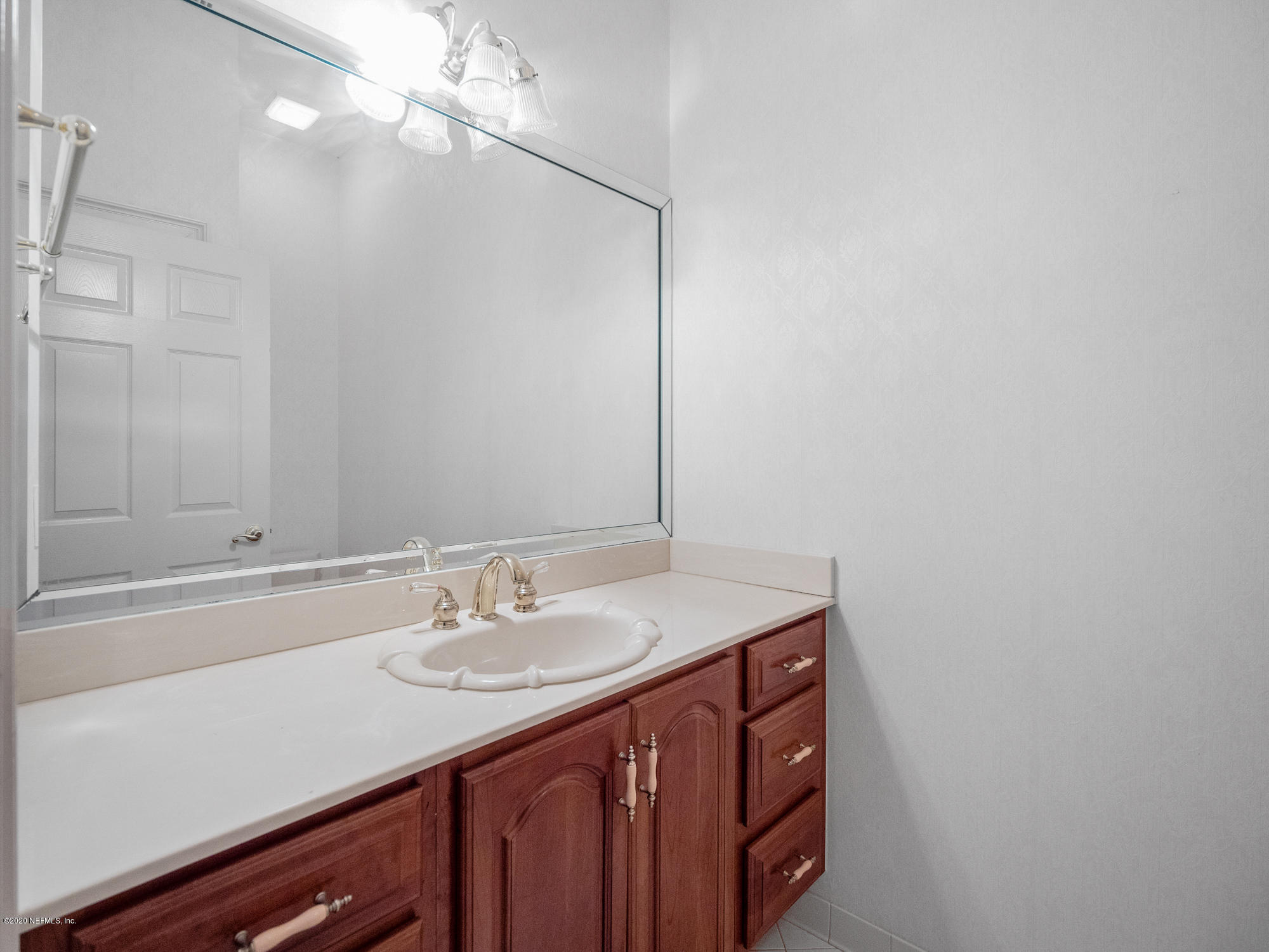 3664 Spinnaker Court Jacksonville, FL 32277 - Photo 18 of 42 a bathroom with a sink a vanity and a mirror