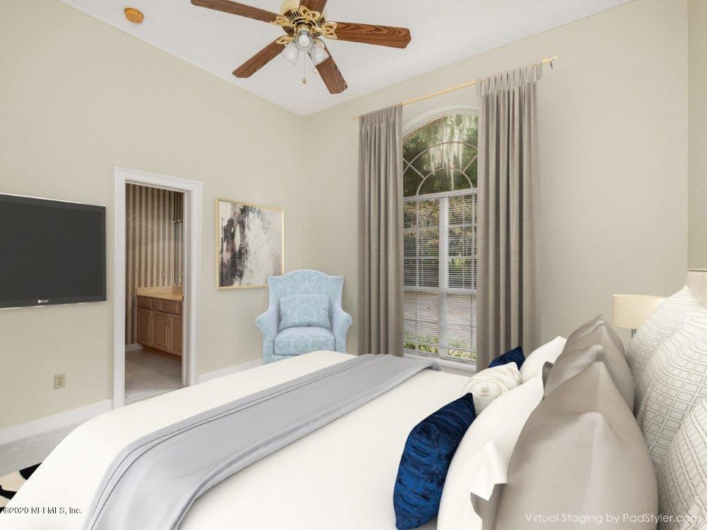 3664 Spinnaker Court Jacksonville, FL 32277 - Photo 20 of 42 a bedroom with a large bed and a chandelier