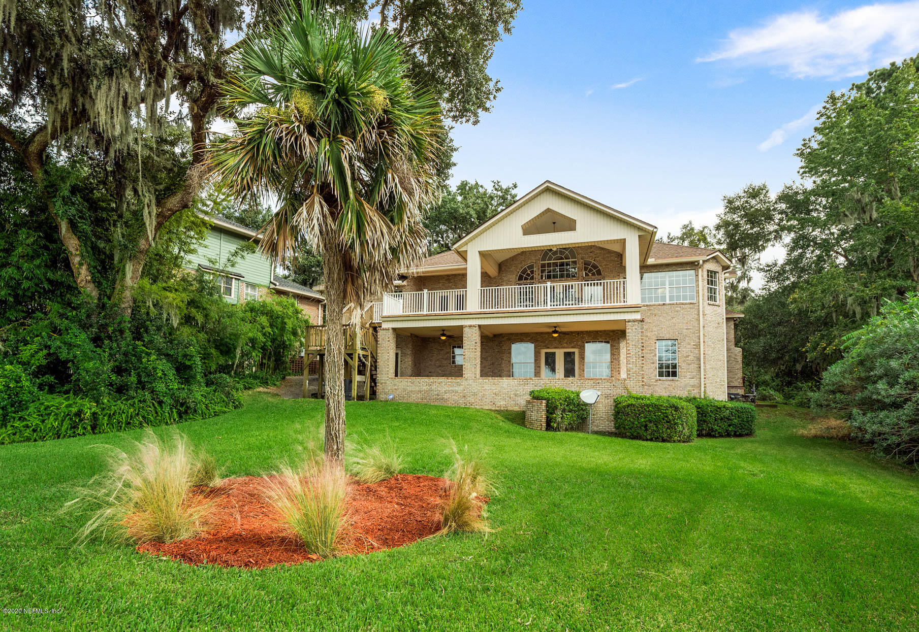 3664 Spinnaker Court Jacksonville, FL 32277 - Photo 2 of 42 a front view of a house with a yard and trees