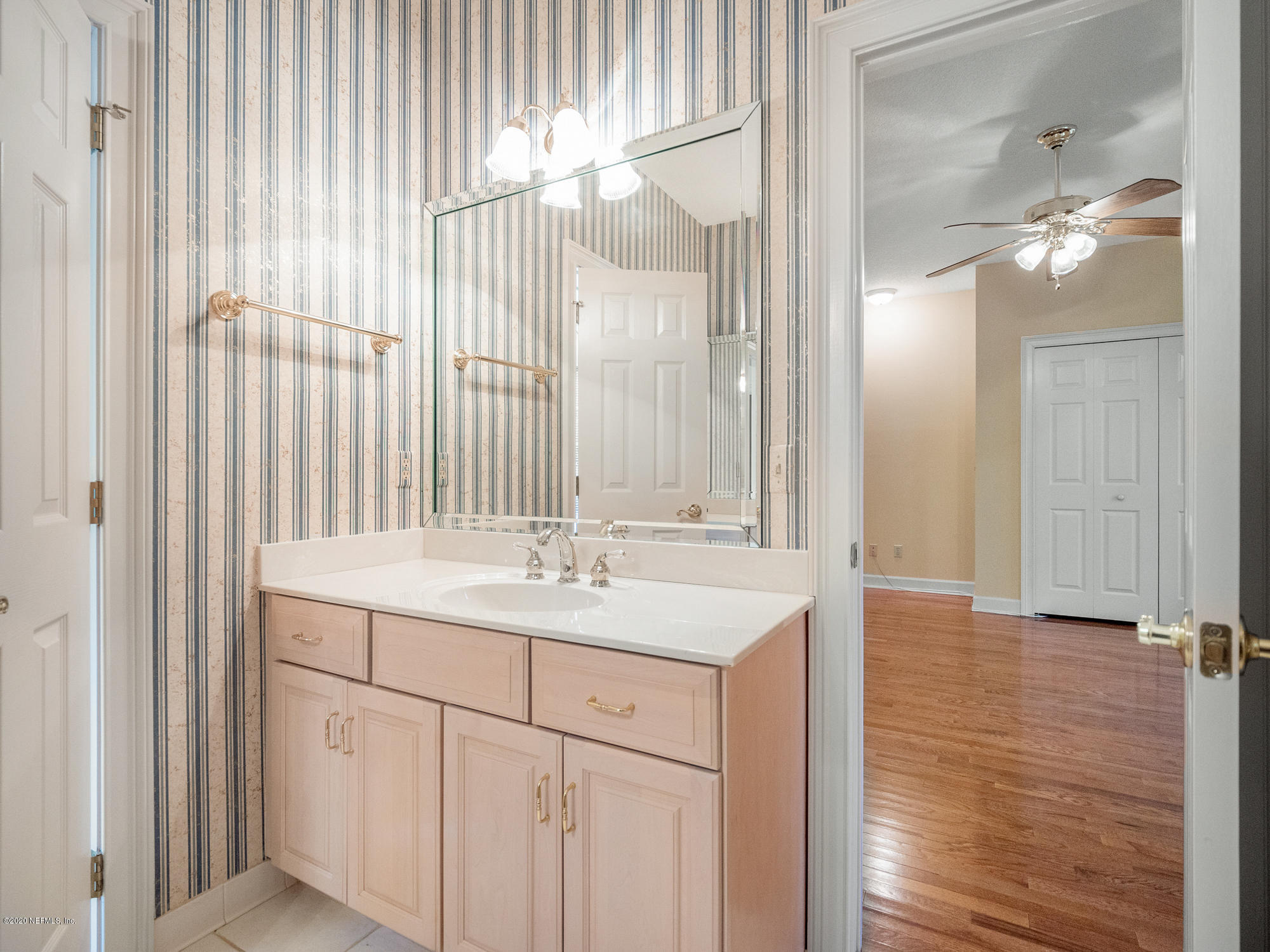 3664 Spinnaker Court Jacksonville, FL 32277 - Photo 21 of 42 a bathroom with a sink and a mirror