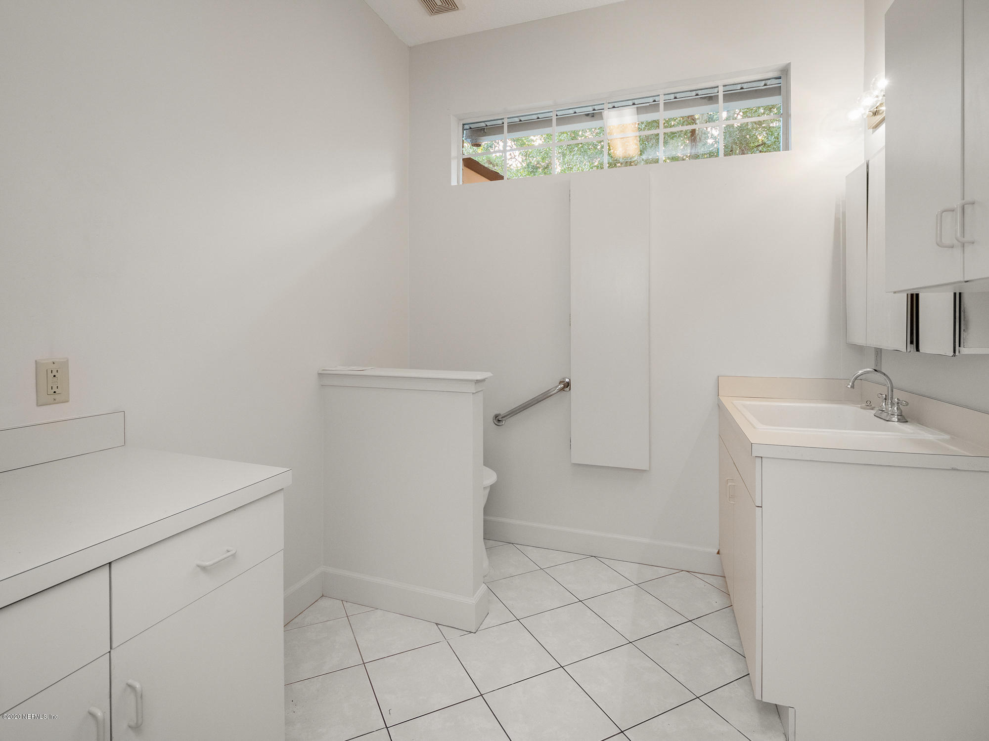 3664 Spinnaker Court Jacksonville, FL 32277 - Photo 22 of 42 a bathroom with a sink a toilet and vanity