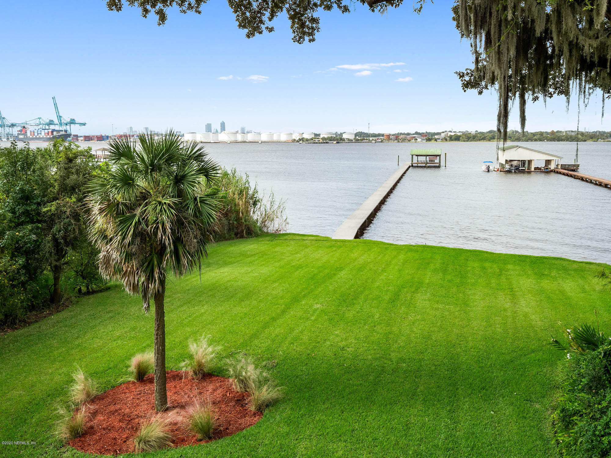 3664 Spinnaker Court Jacksonville, FL 32277 - Photo 3 of 42 a view of a lake with a big yard and palm trees
