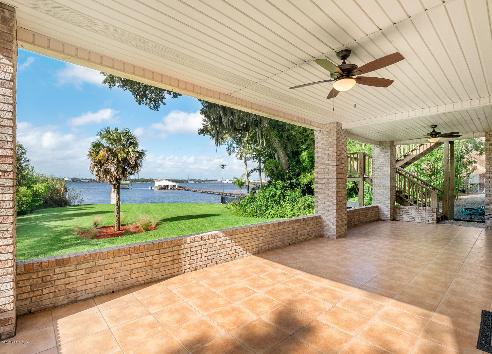 3664 Spinnaker Court Jacksonville, FL 32277 - Photo 31 of 42 a view of a porch with a table and chairs under an umbrella