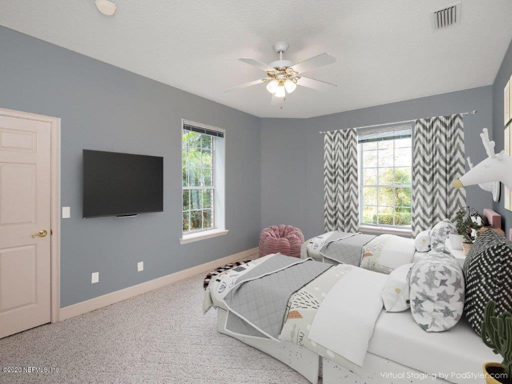 3664 Spinnaker Court Jacksonville, FL 32277 - Photo 32 of 42 a bedroom with a bed and a flat screen tv