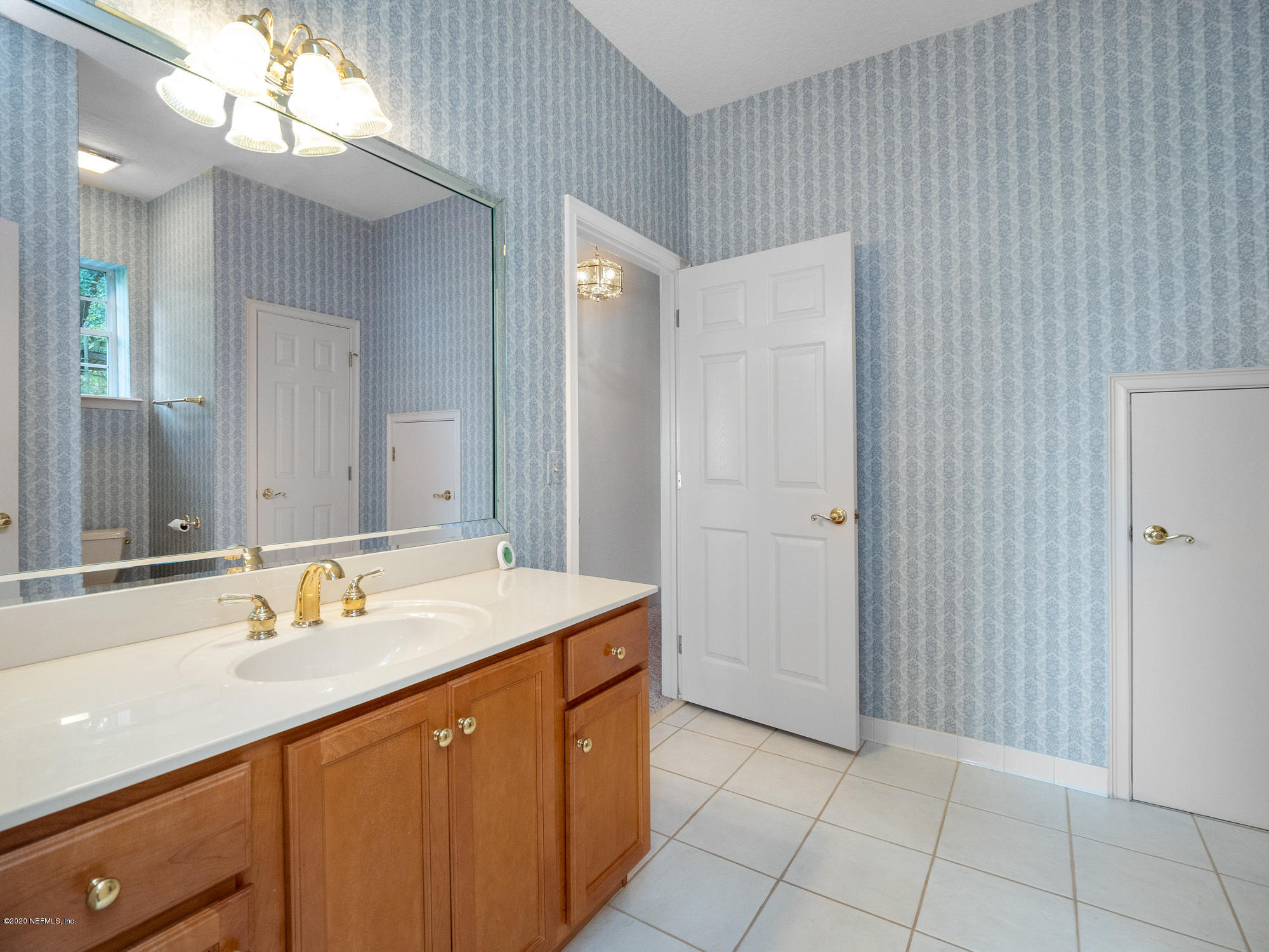 3664 Spinnaker Court Jacksonville, FL 32277 - Photo 34 of 42 a bathroom with a sink a mirror and a shower