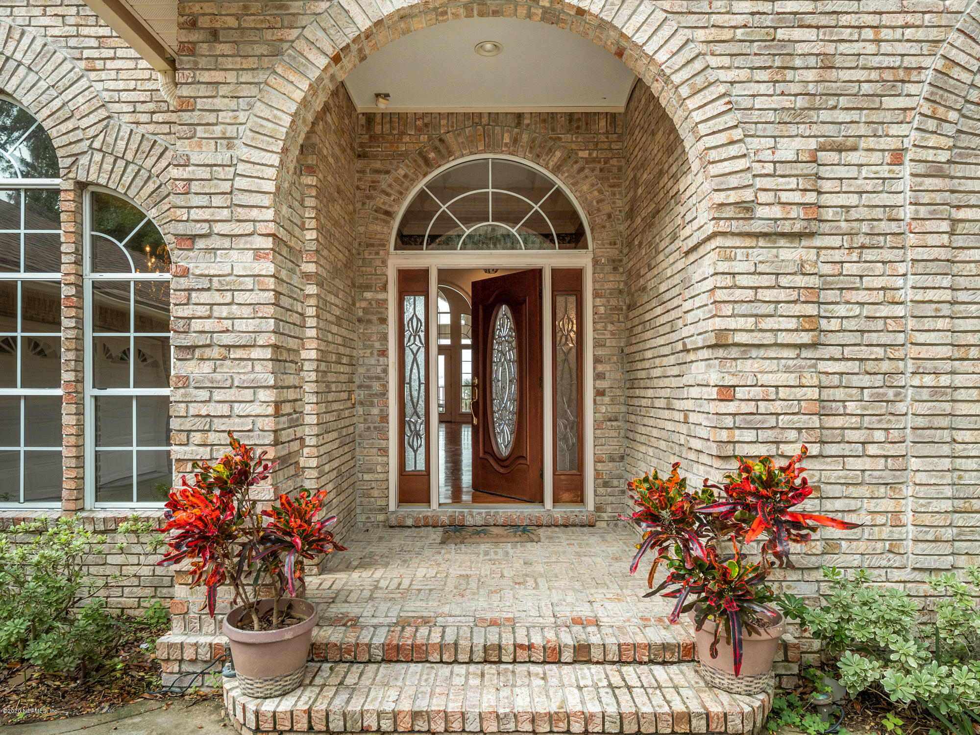 3664 Spinnaker Court Jacksonville, FL 32277 - Photo 4 of 42 a front view of a house with a porch