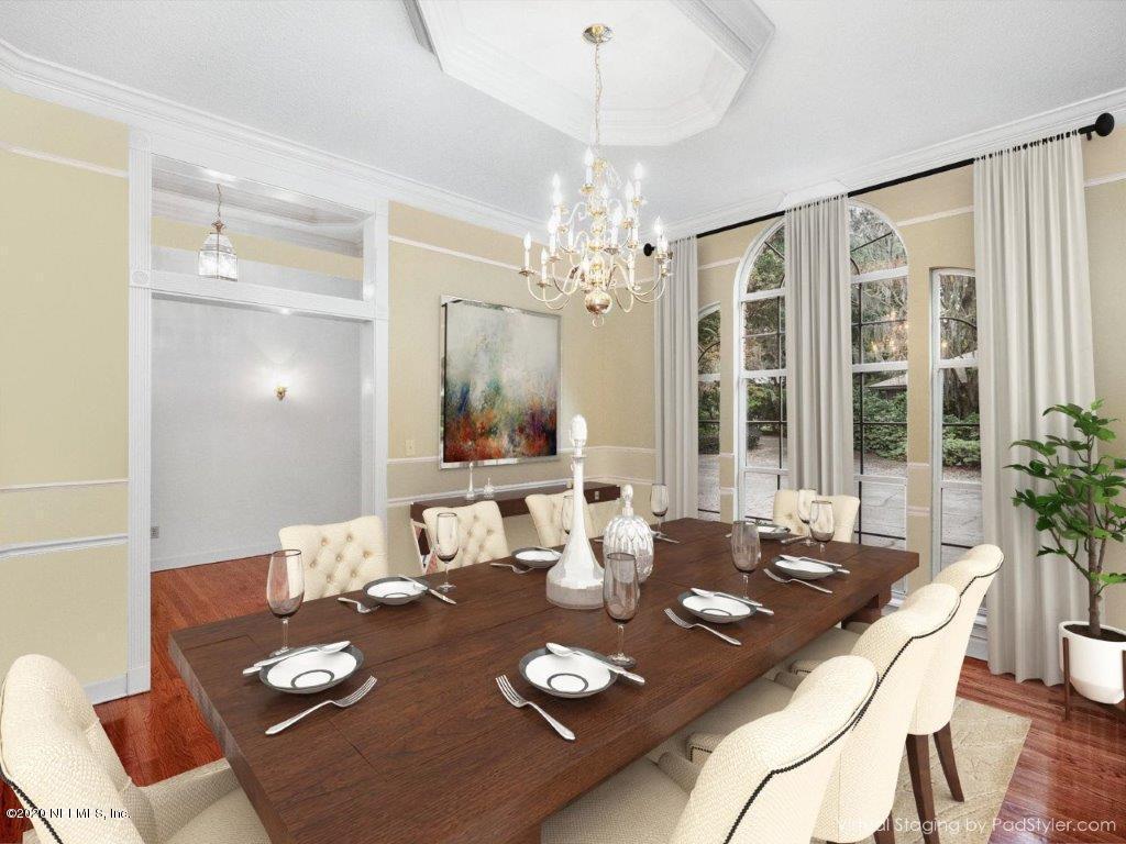 3664 Spinnaker Court Jacksonville, FL 32277 - Photo 6 of 42 a view of a dining room and livingroom with furniture wooden floor a chandelier
