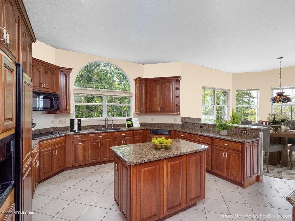 3664 Spinnaker Court Jacksonville, FL 32277 - Photo 9 of 42 a kitchen with stainless steel appliances granite countertop a sink a stove a counter top space and cabinets
