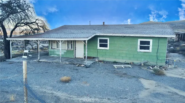 a backyard of a house with table and chairs