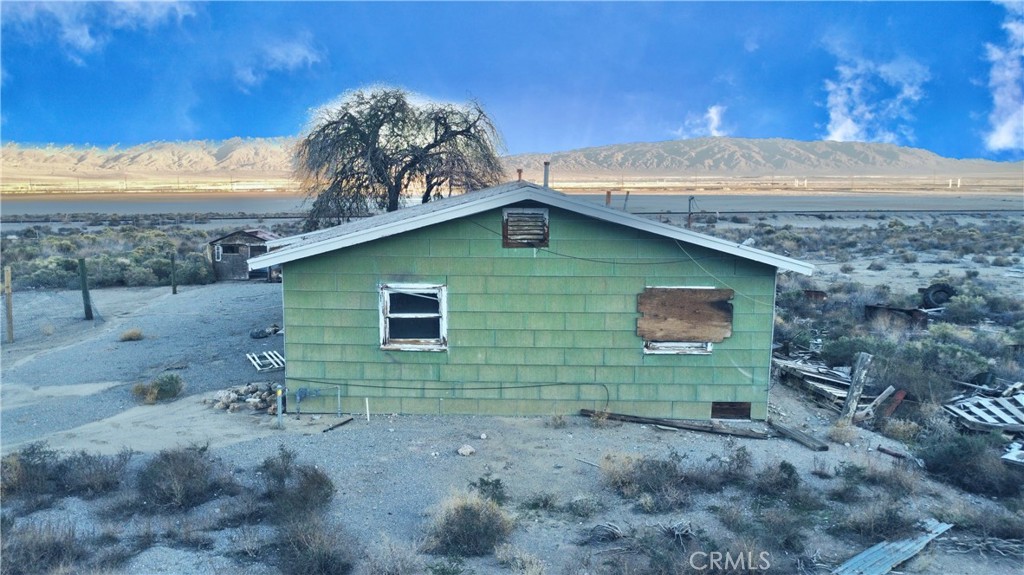 12331 Beech Street Trona, CA 93562 - Photo 6 of 16 a view of a house with a backyard
