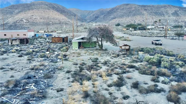a view of a dry yard with a mountain