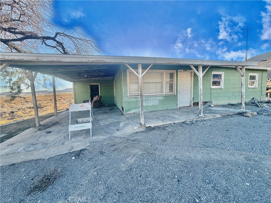 12331 Beech Street Trona, CA 93562 - Photo 9 of 16 a view of a house with a porch and a large window