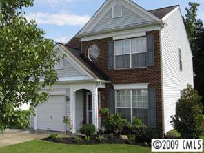 14054 Dingess Road Charlotte, NC 28273 - Photo 1 of 8 a front view of a house with a yard and garage