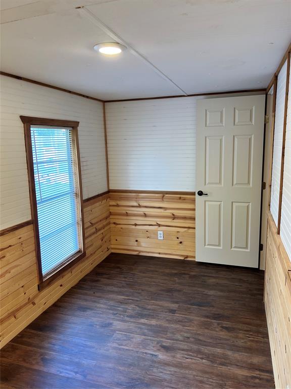 2334 San Bar Road, Unit 46 Graford, TX 76449 - Photo 20 of 37 a view of empty room with wooden floor and cabinet