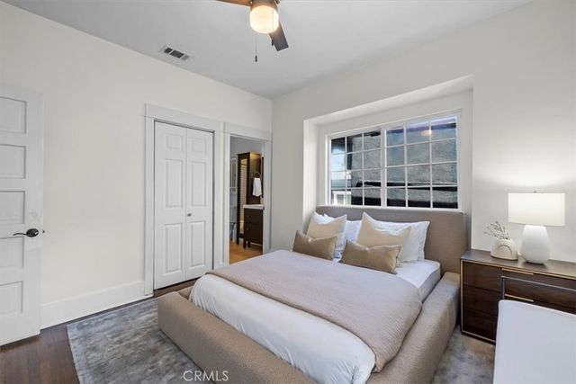 a bedroom with a large bed and a window