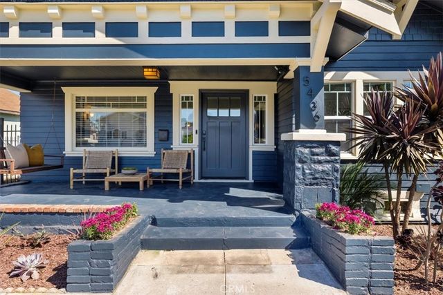 a front view of house with outdoor seating