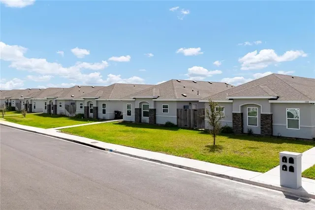 a view of a house with swimming pool and yard