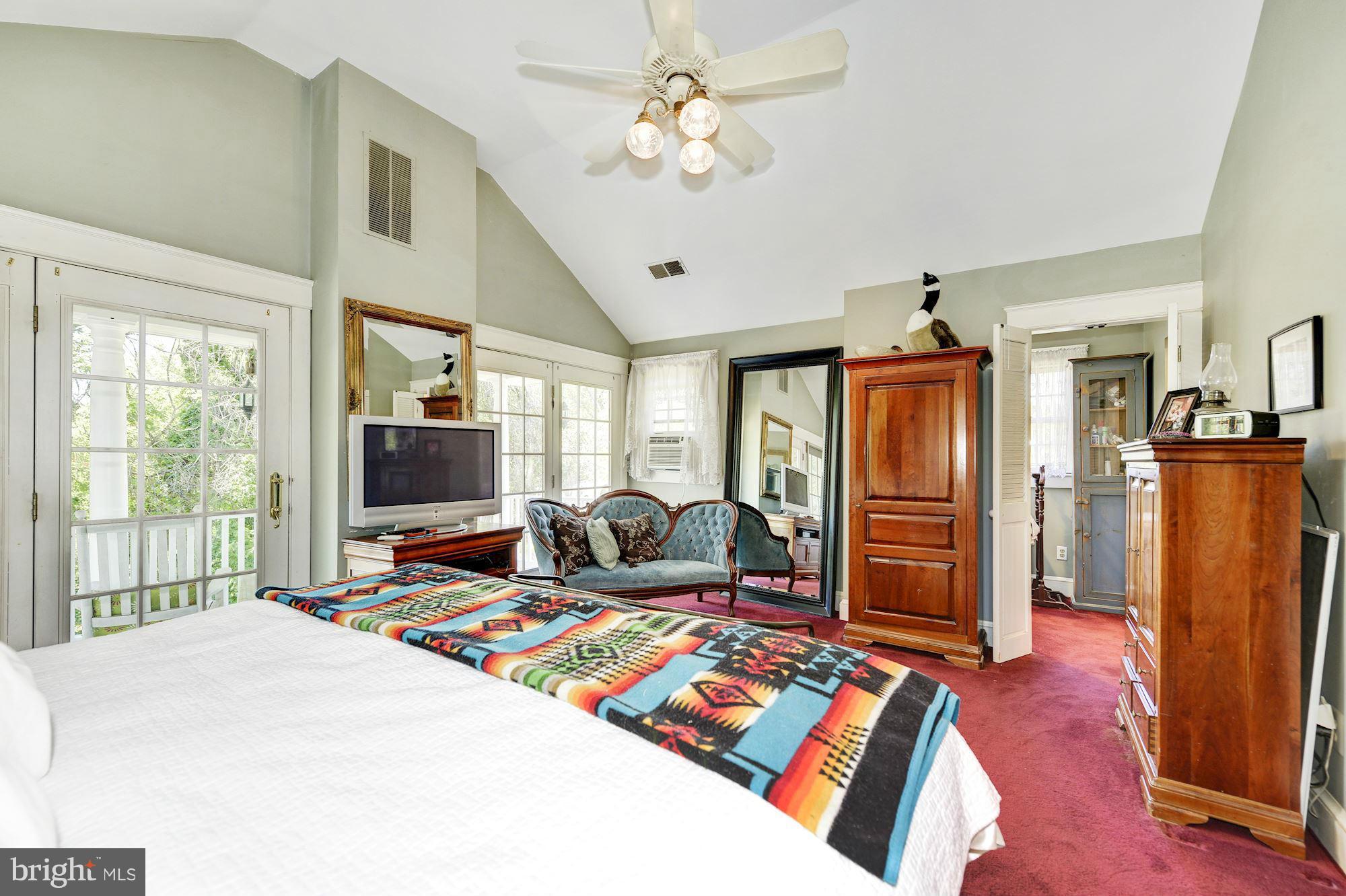 4011 Gallows Road Annandale, VA 22003 - Photo 14 of 27 a bed room with furniture and a flat screen tv