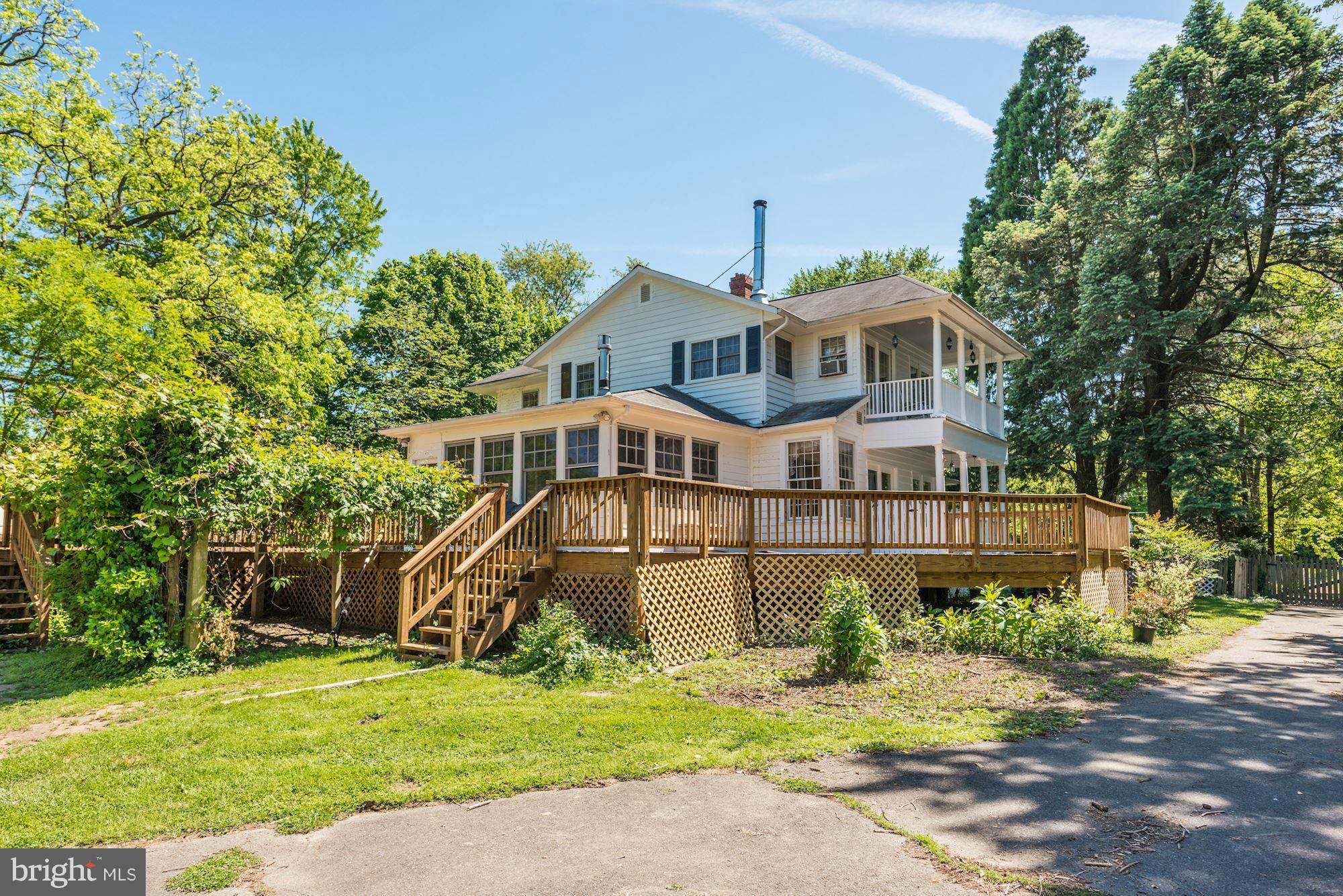 4011 Gallows Road Annandale, VA 22003 - Photo 23 of 27 a front view of a house with a garden and trees