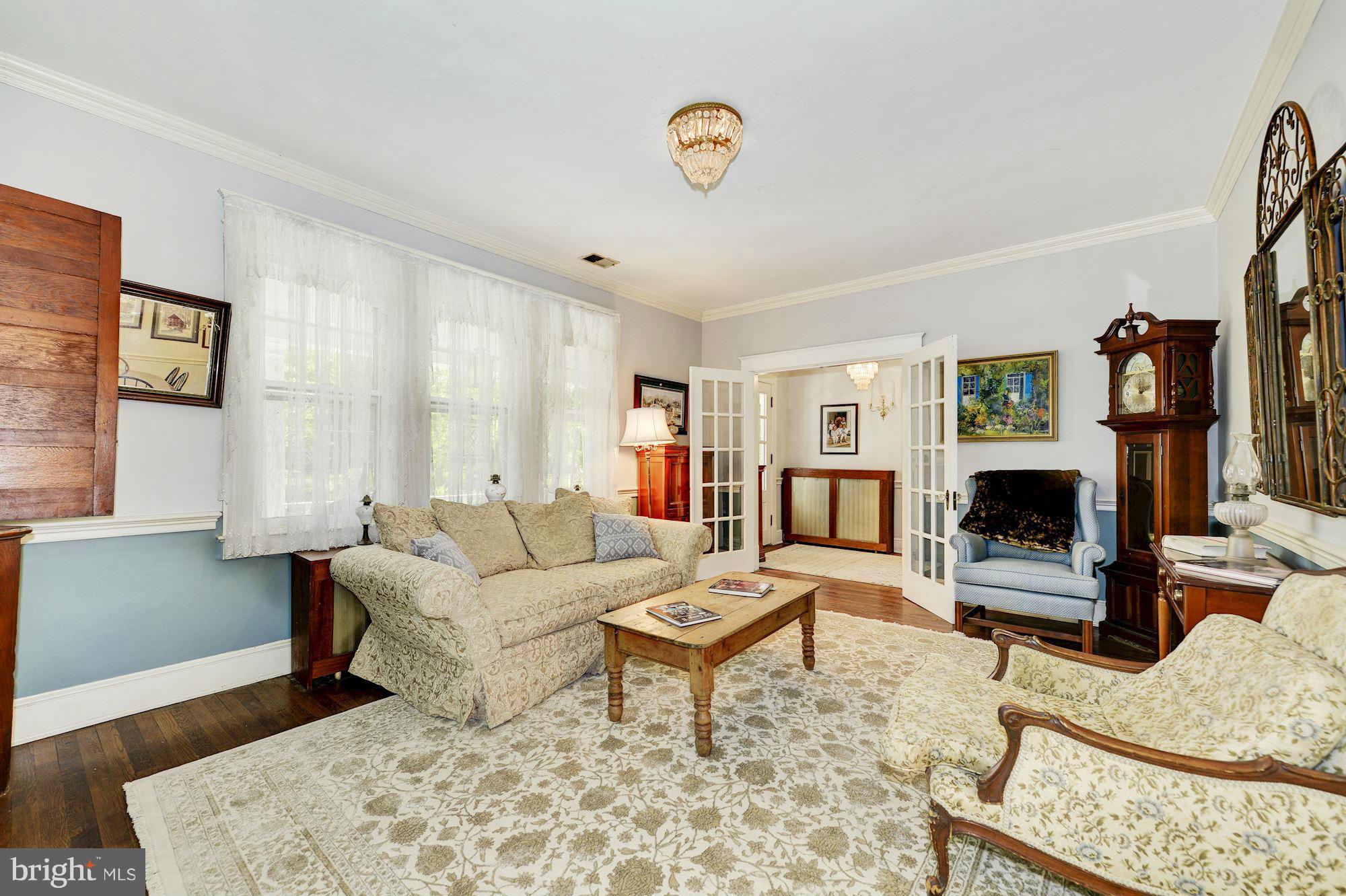 4011 Gallows Road Annandale, VA 22003 - Photo 6 of 27 a living room with furniture a flat screen tv and a fireplace