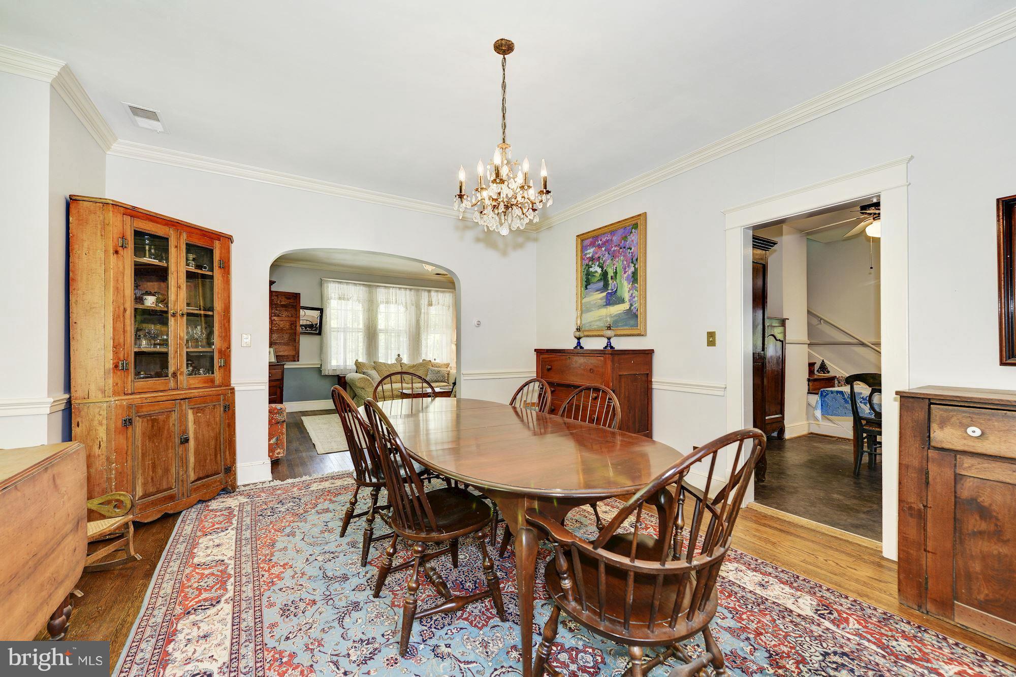 4011 Gallows Road Annandale, VA 22003 - Photo 7 of 27 a dining room with furniture a chandelier and wooden floor