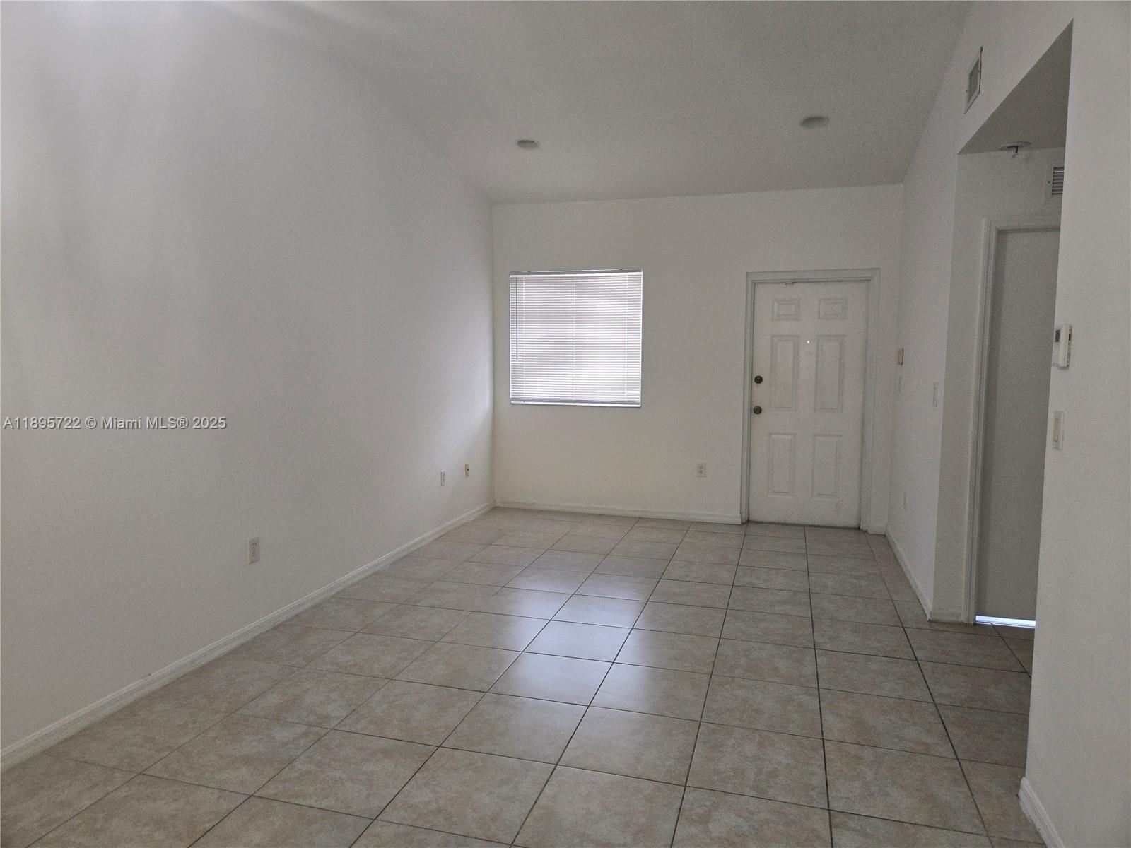 2920 Southeast 12th Road, Unit 20430 Homestead, FL 33035 - Photo 2 of 10 a view of an empty room and window