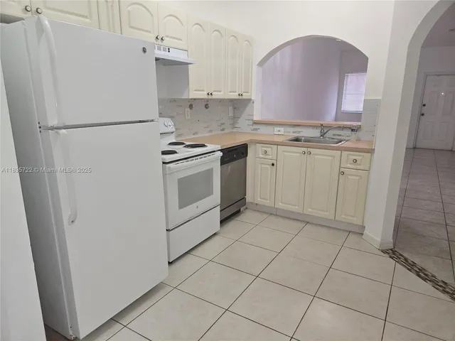 a white refrigerator freezer sitting inside of a kitchen
