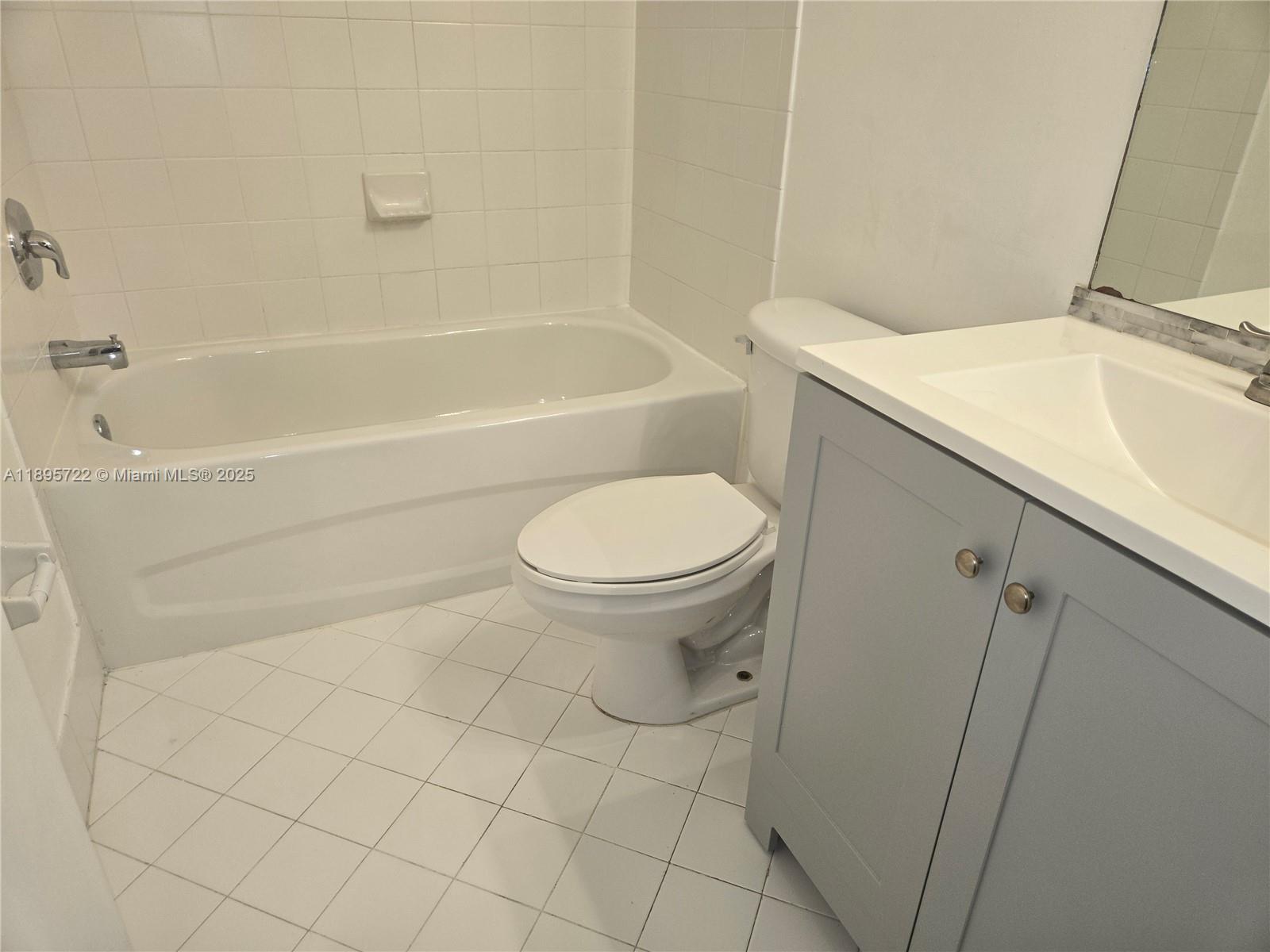 2920 Southeast 12th Road, Unit 20430 Homestead, FL 33035 - Photo 6 of 10 a bathroom with a sink a toilet and bathtub