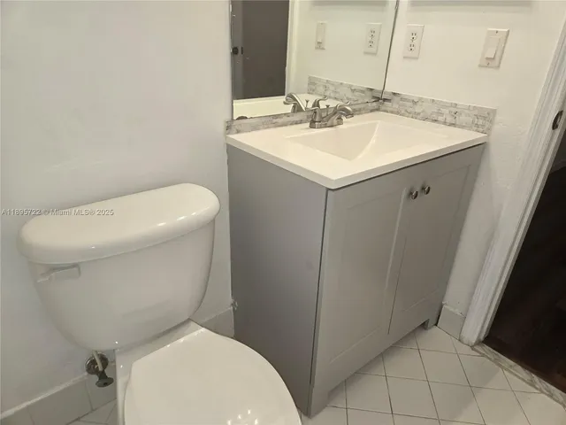 a white toilet sitting next to a bathroom sink