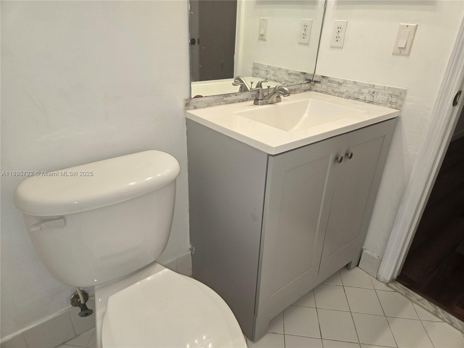 2920 Southeast 12th Road, Unit 20430 Homestead, FL 33035 - Photo 7 of 10 a white toilet sitting next to a bathroom sink