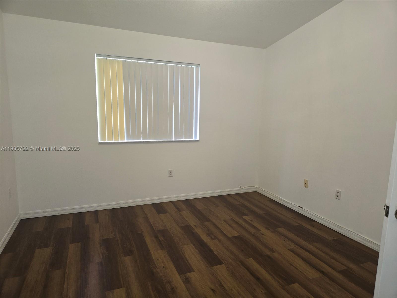 2920 Southeast 12th Road, Unit 20430 Homestead, FL 33035 - Photo 8 of 10 wooden floor in an empty room