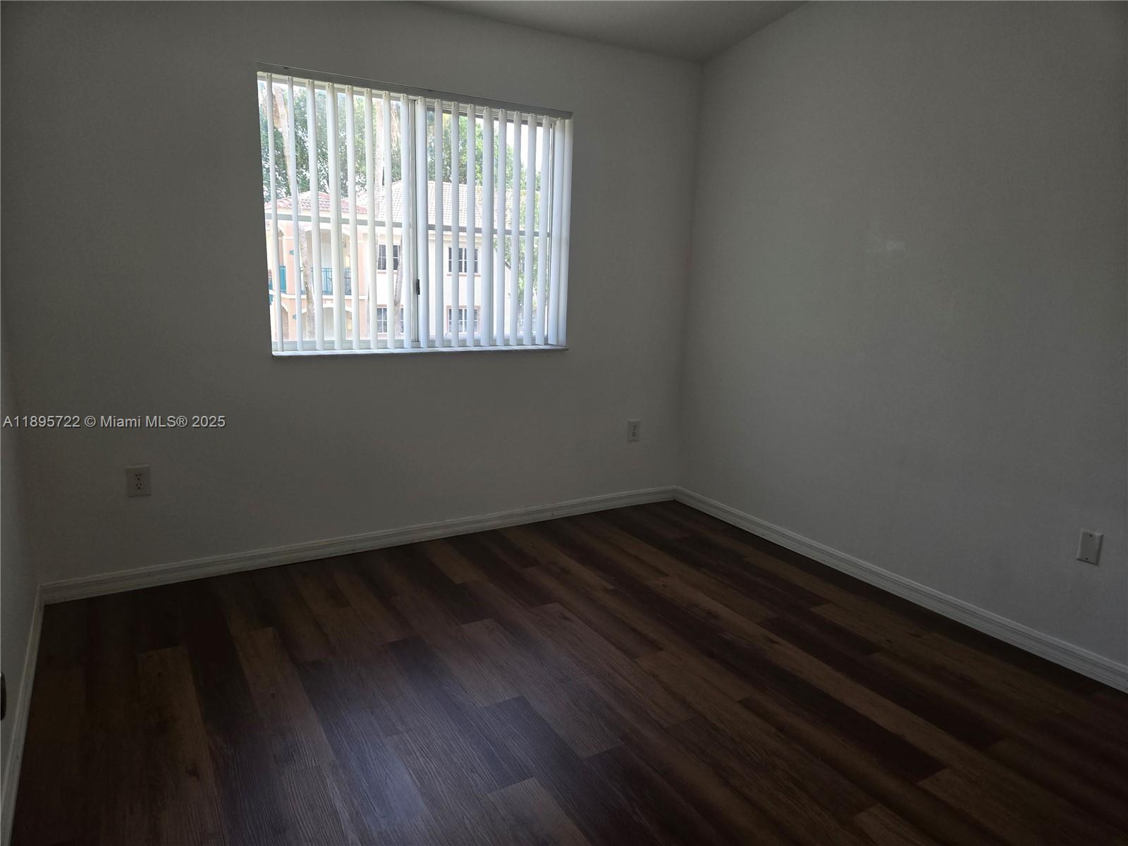 2920 Southeast 12th Road, Unit 20430 Homestead, FL 33035 - Photo 10 of 10 a view of an empty room with wooden floor and a window
