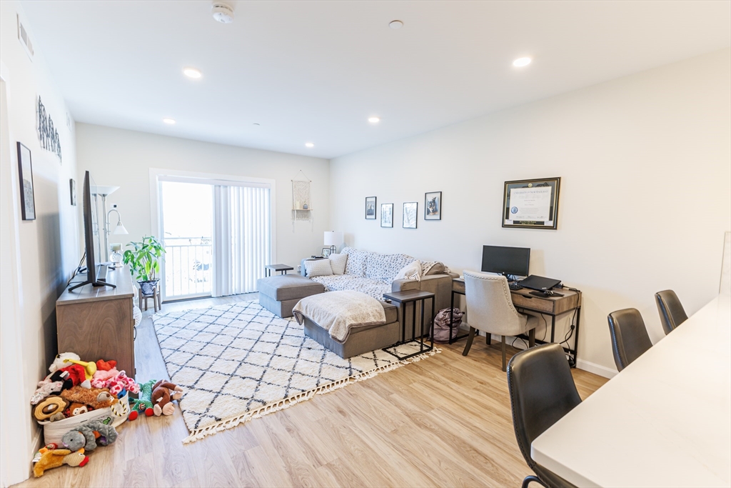 a living room with furniture and flowers