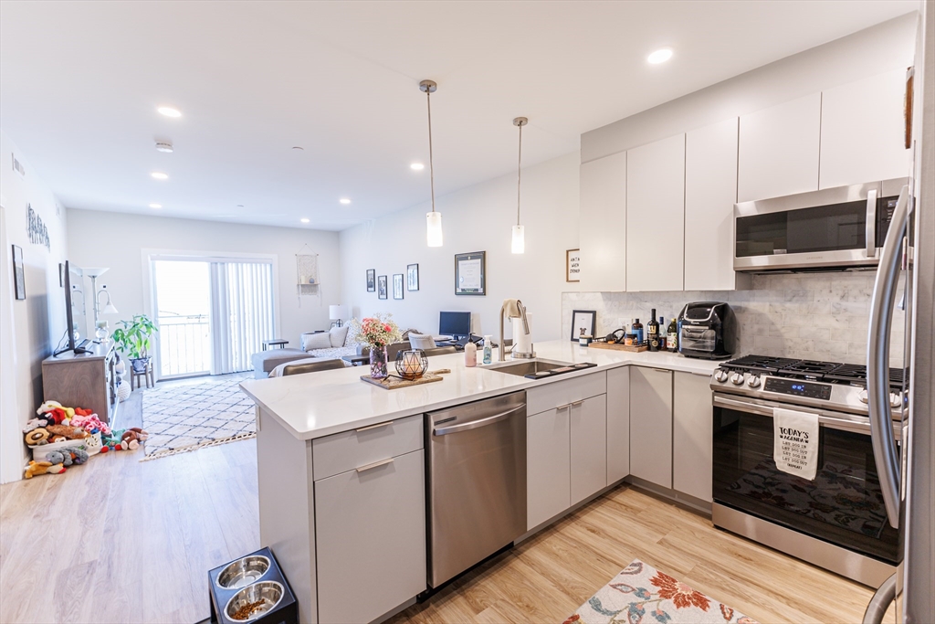 458 Washington Street, Unit 304 Boston, MA 02135 - Photo 5 of 13 a kitchen with a sink stove and microwave