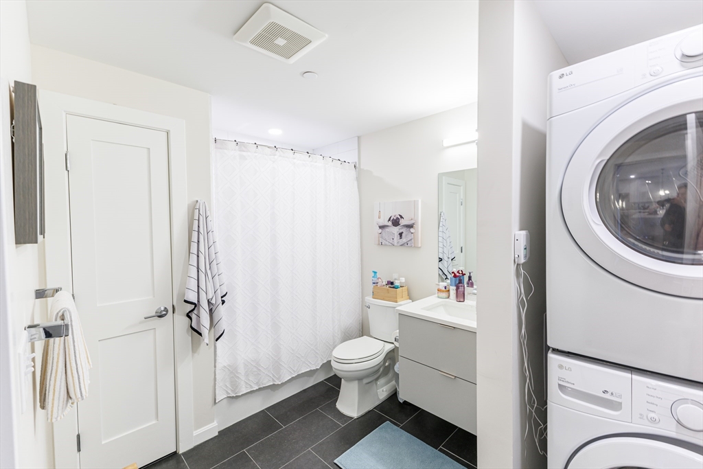 458 Washington Street, Unit 304 Boston, MA 02135 - Photo 8 of 13 a bathroom with a sink a toilet and shower