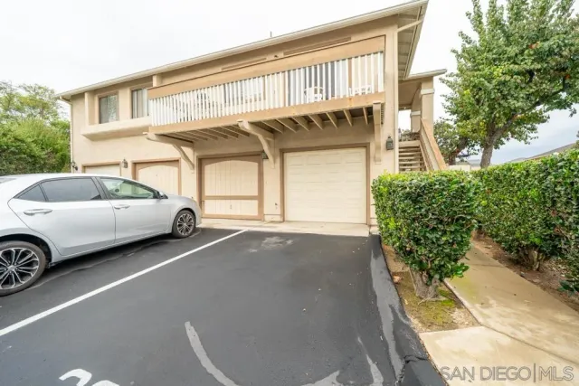a view of a car parked in front of a house
