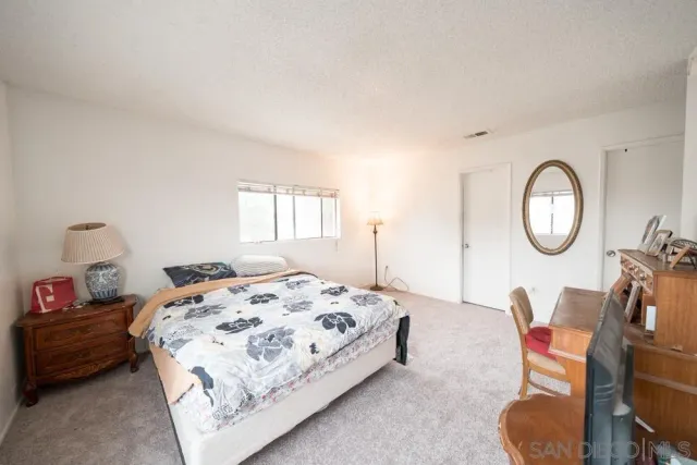 a bedroom with bed and a chair