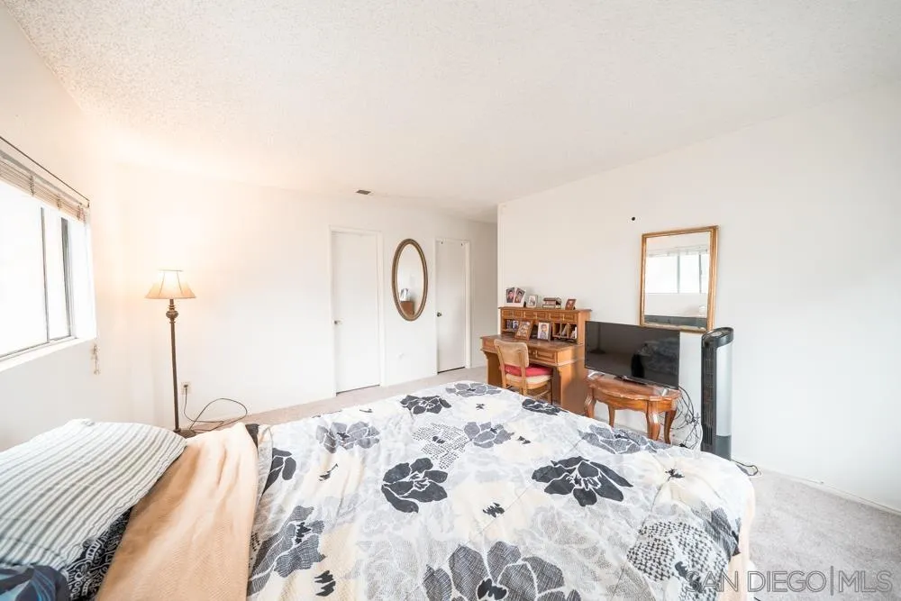 7967 Arly Court, Unit 24 Santee, CA 92071 - Photo 7 of 25 a bedroom with a bed a table and chair